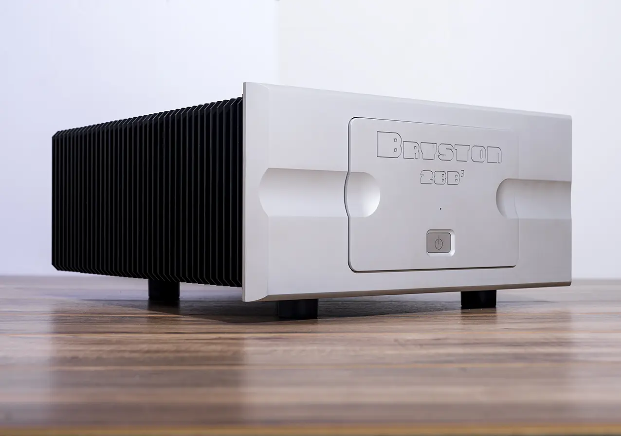High-end audio amplifier with sleek silver front and black heat sinks.