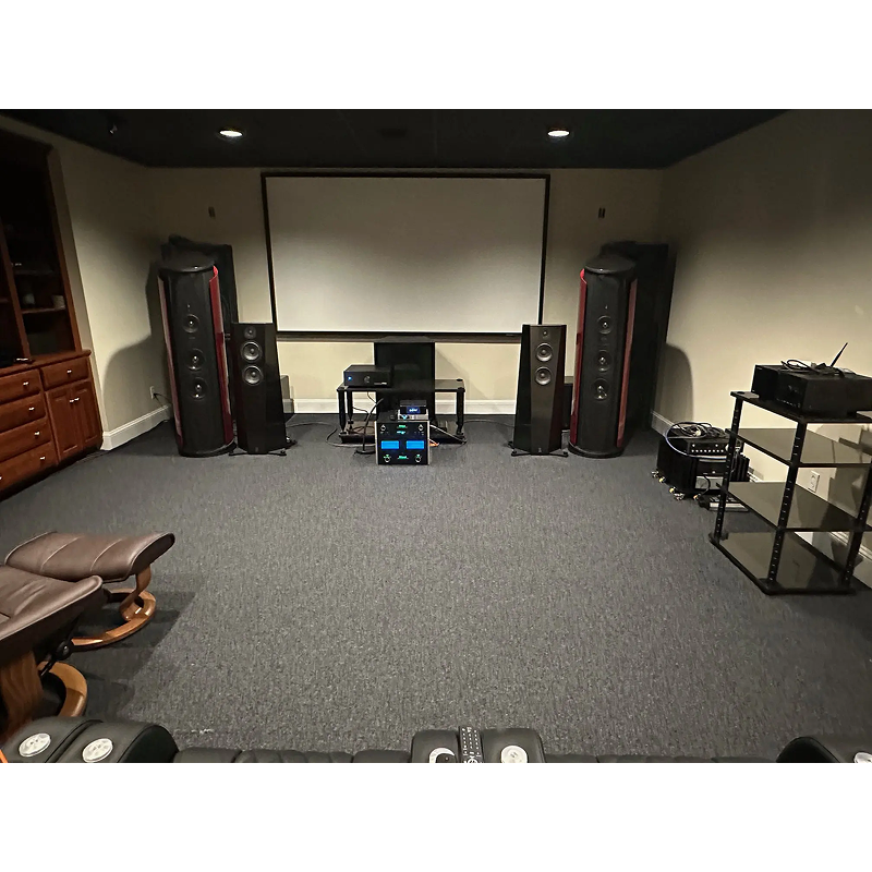 Home theater setup with large speakers and a projector screen.