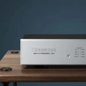 Modern audio amplifier with sleek design on wooden table.
