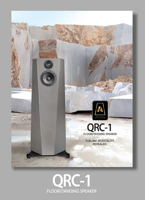 Sleek QRC-1 loudspeaker in a modern setting.