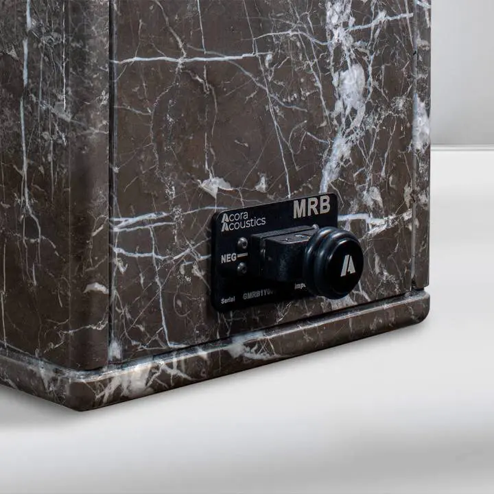 Close-up of a marble base with a black speaker control panel.