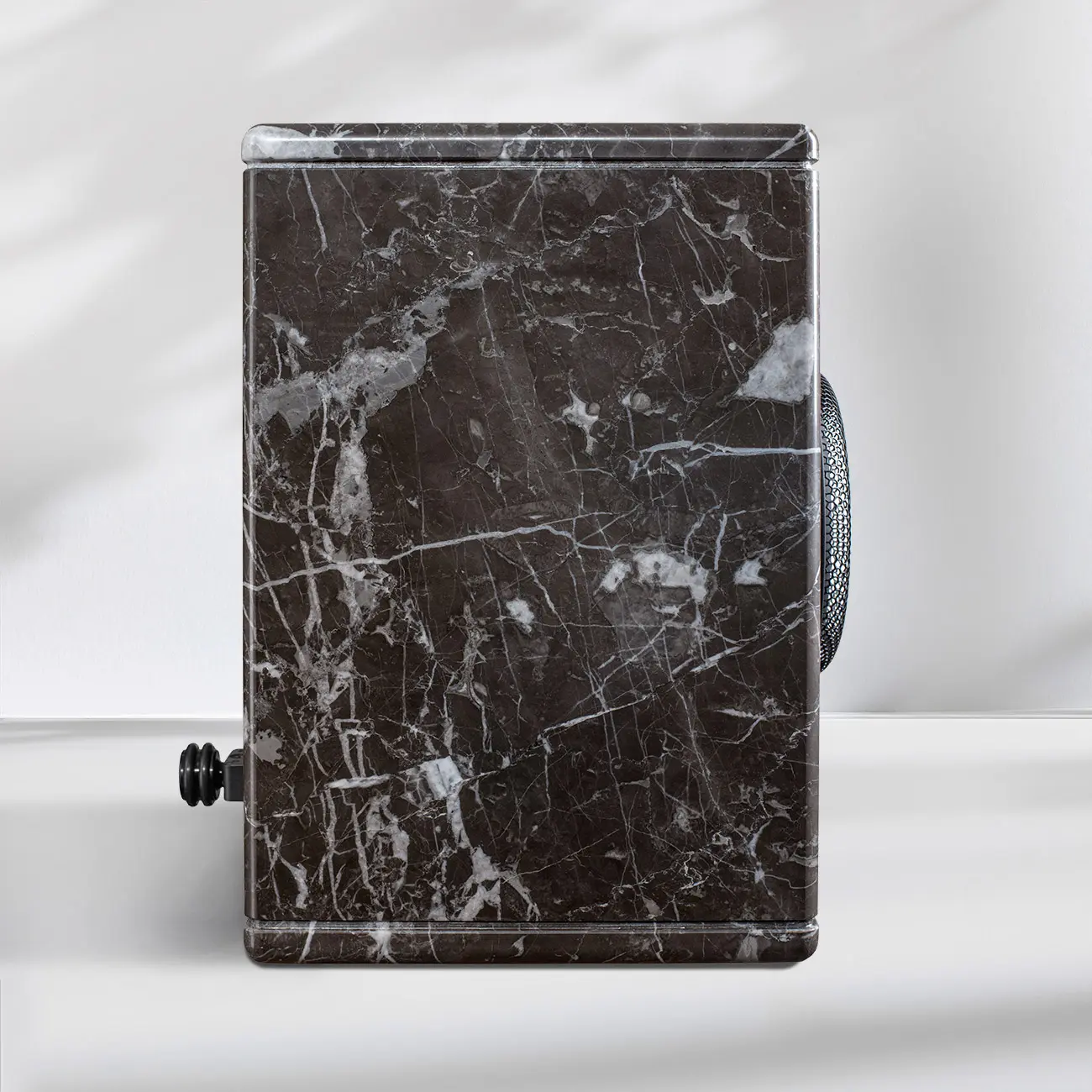 Black marble suitcase with white veins and a handle.
