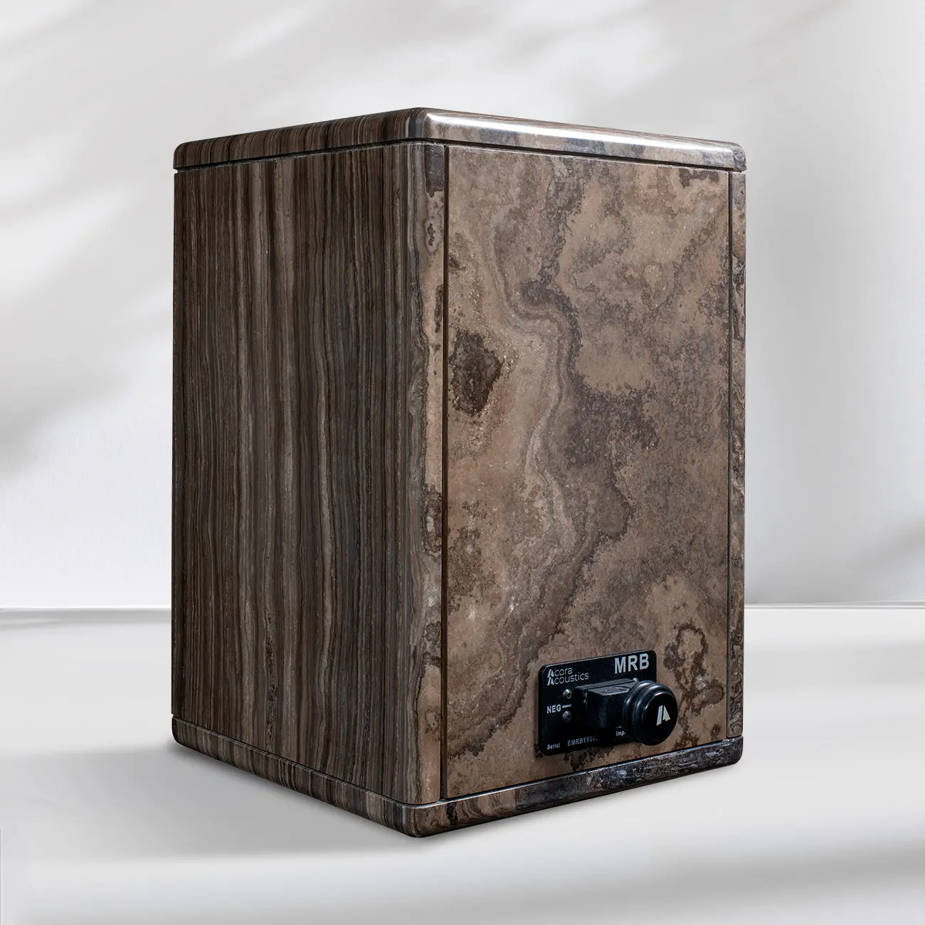 A vintage wooden speaker with a textured finish on a white surface.