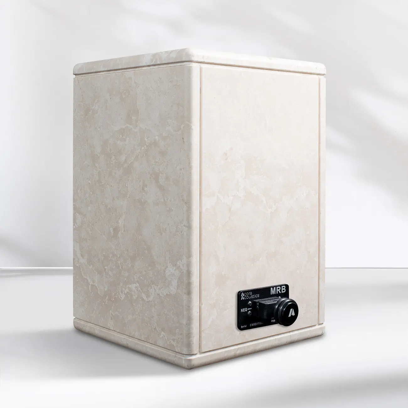 Minimalist white speaker with black controls on a plain background.