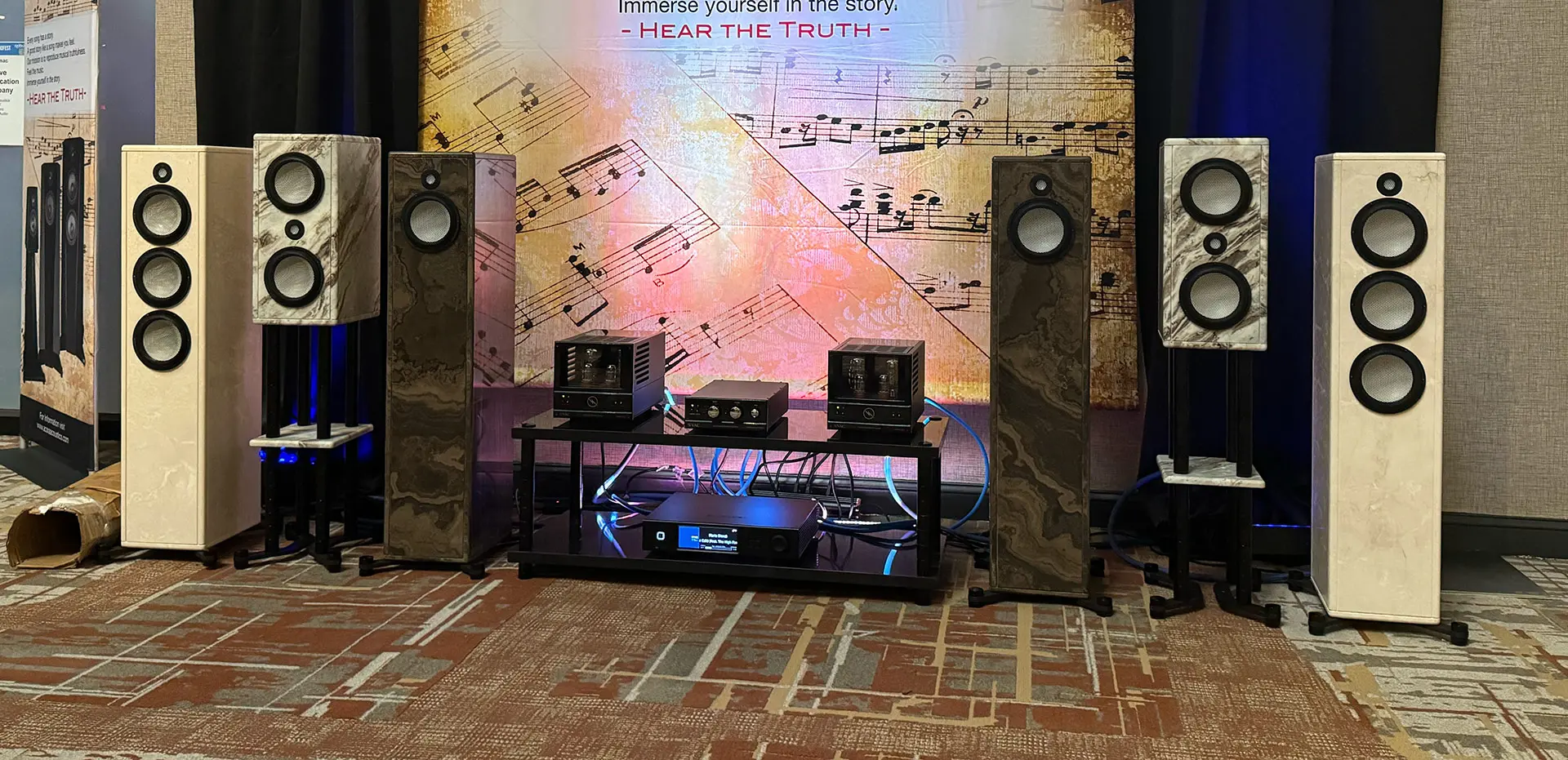 High-end audio setup with speakers and amplifiers in a stylish room.