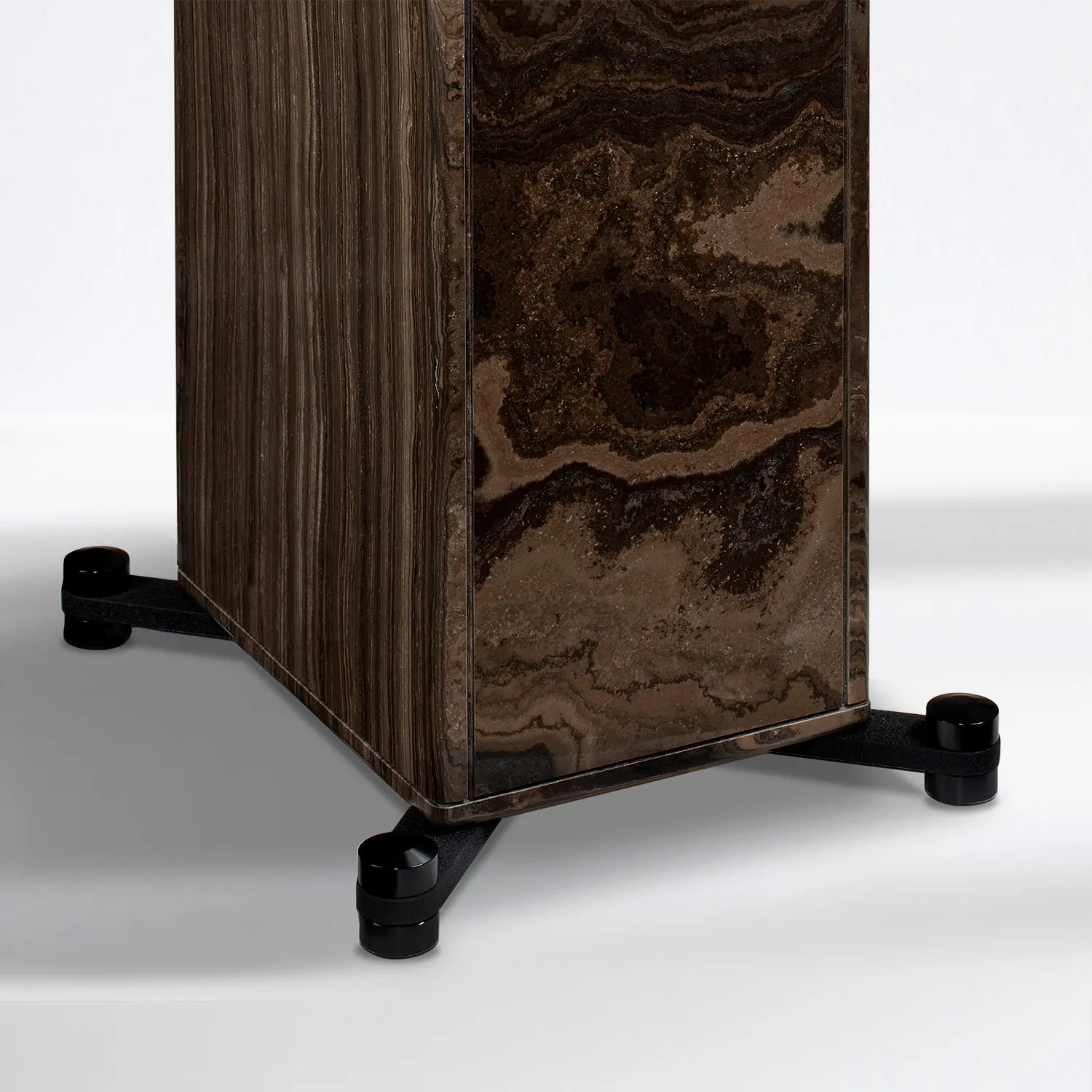 Close-up of a wooden furniture leg with black caster wheels.