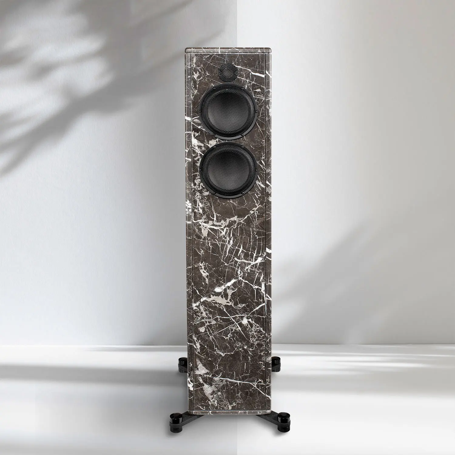 Elegant marble speaker with sleek black drivers standing on a minimalistic base.