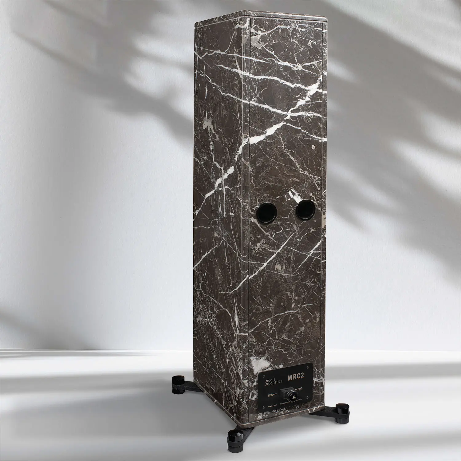Tall rectangular marble speaker with white veins and dual drivers.