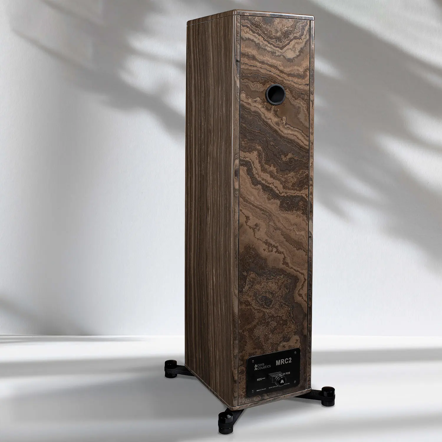Tall wooden speaker with natural grain and black base.