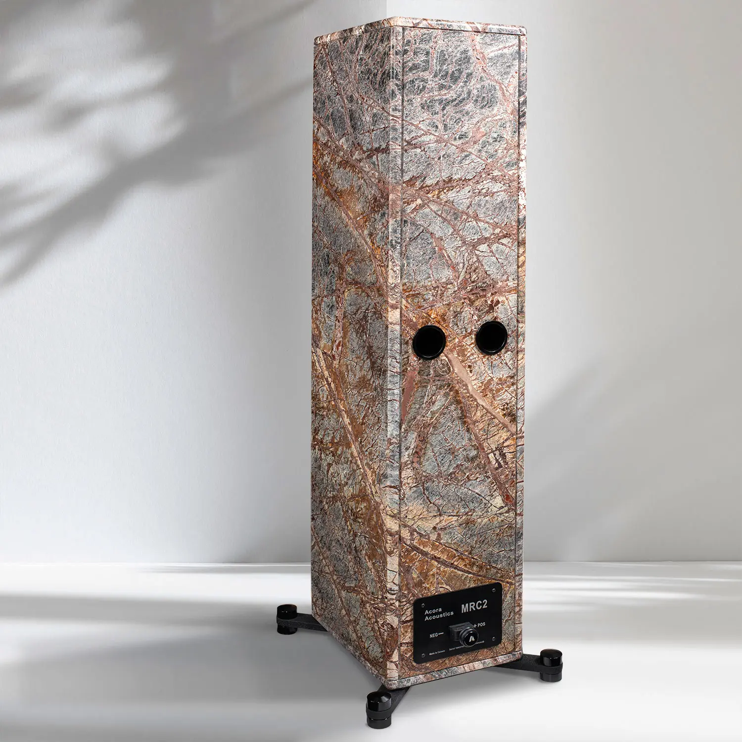 Tall rectangular speaker with artistic wood and metal design on wheels.