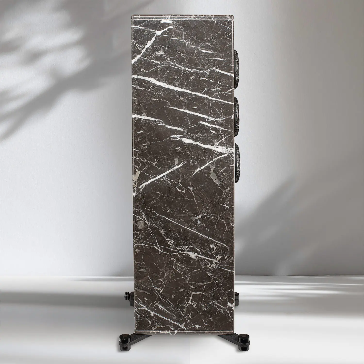 Tall, rectangular dark marble sculpture with white veins on a stand.