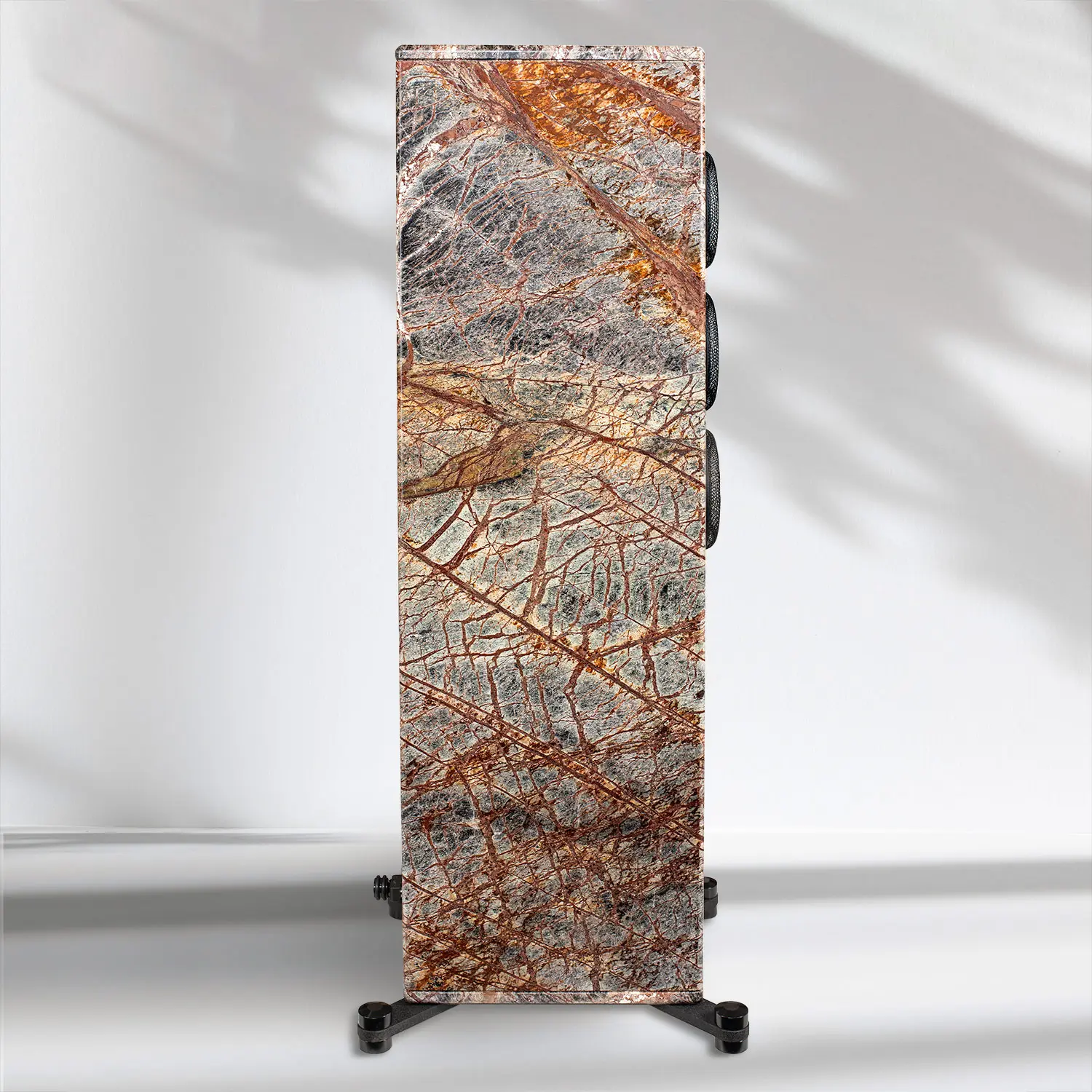 Tall stone slab with intricate orange and gray patterns on a black stand.