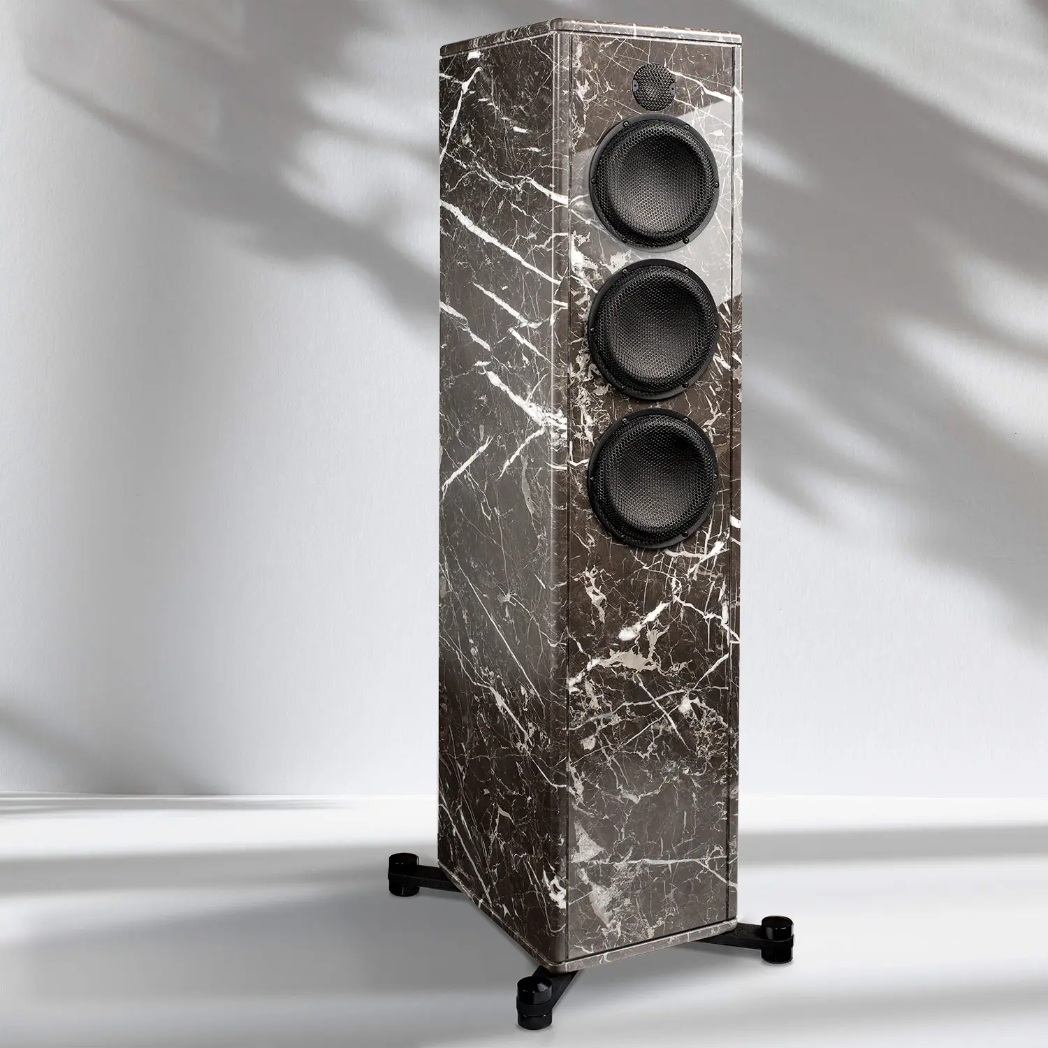 Tall marble-finished speaker with three drivers on a stand.