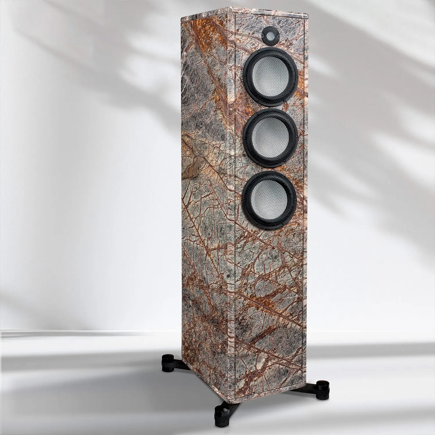 Tall, marble-textured speaker with three drivers and wheels.