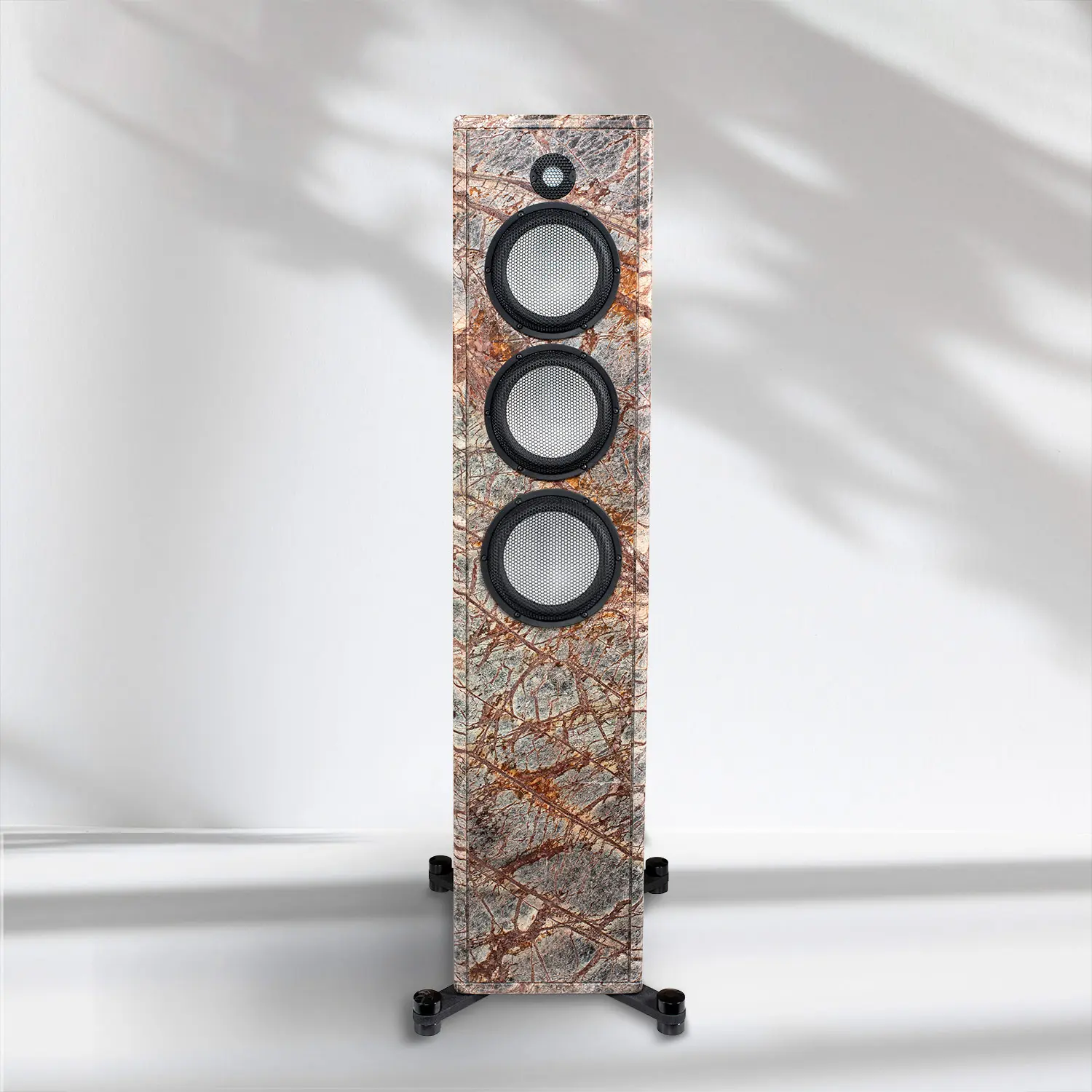 Tall speaker with three drivers and a textured finish, standing on a black stand.