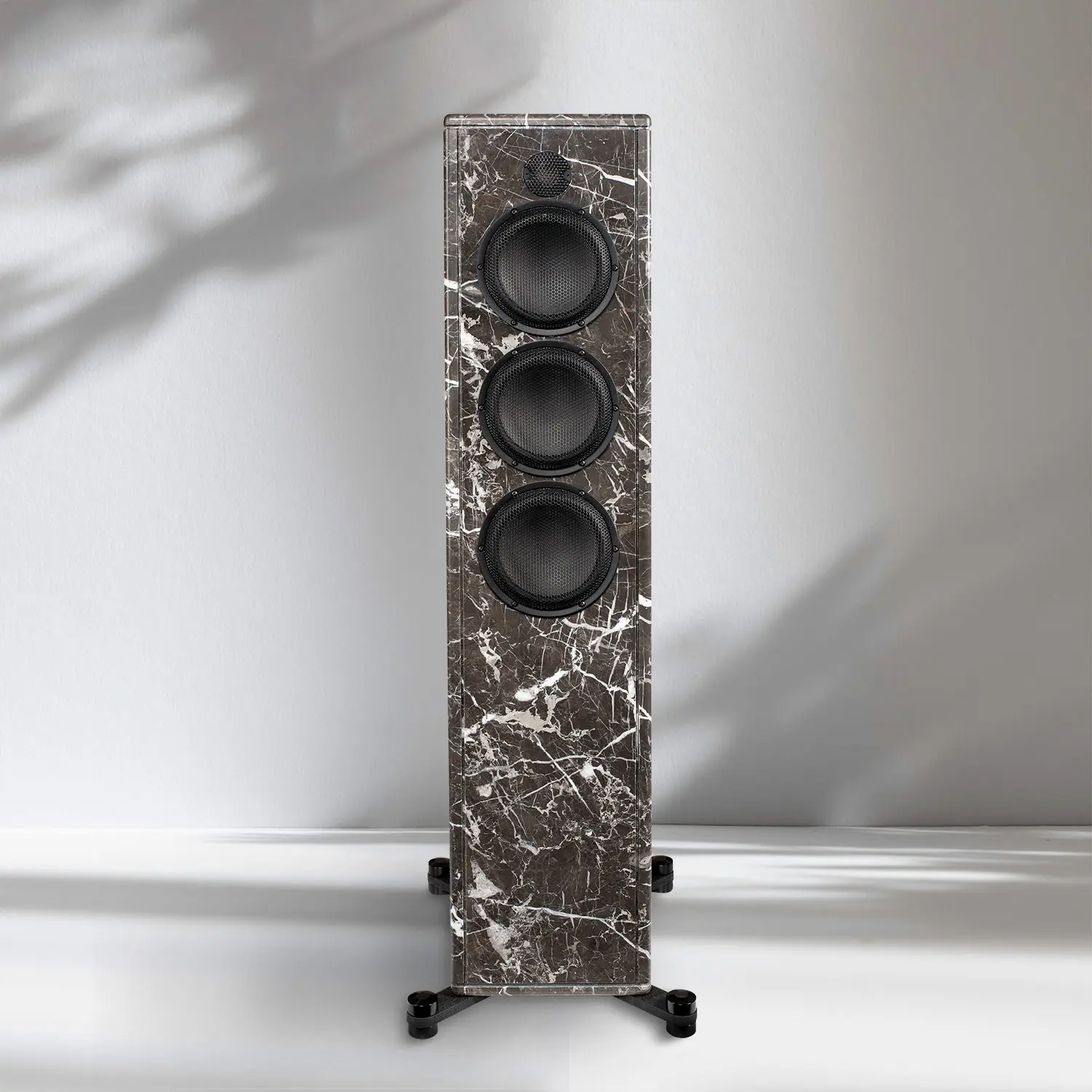 Tall marble-patterned floor speaker with three drivers on a white background.