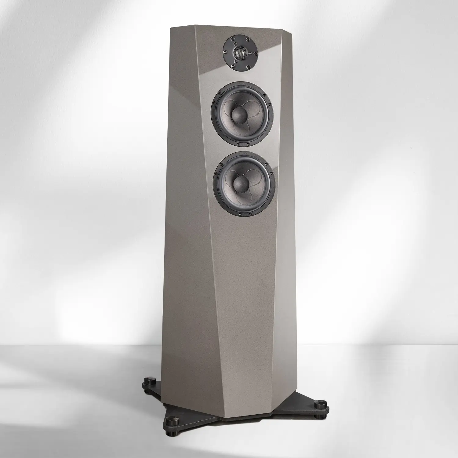 Modern floor-standing speaker with a sleek gray finish and black base.
