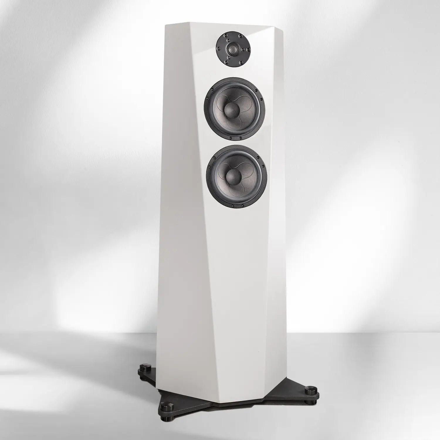 Tall white floor-standing speaker with dual woofers and tweeter.