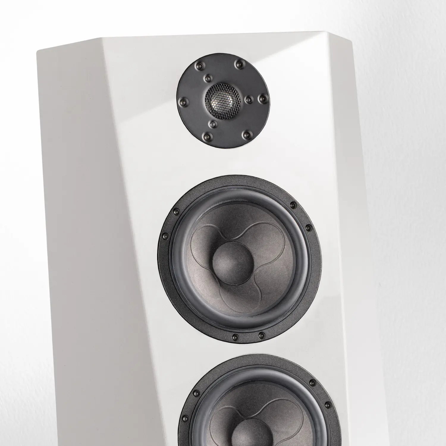 Modern white floor-standing speaker with dual woofers and a tweeter.