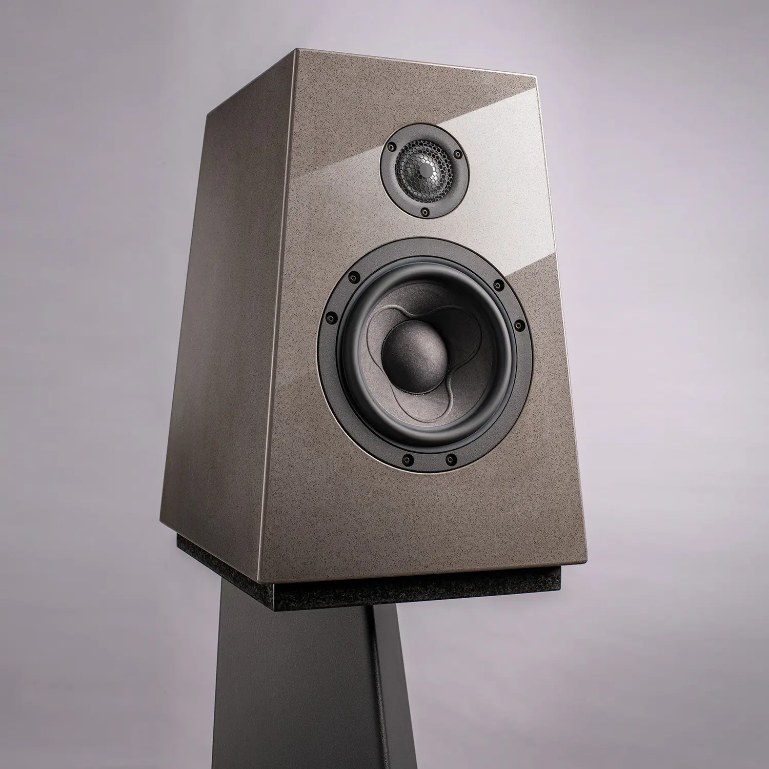 Modern high-fidelity speaker on a stand with sleek design.