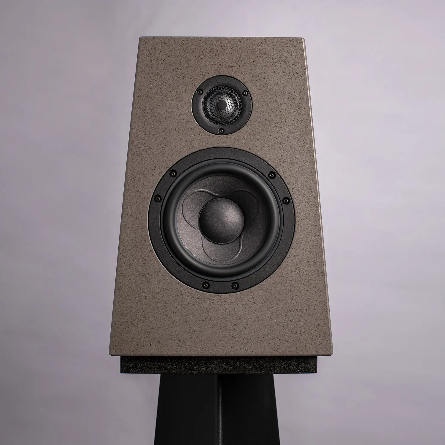 A gray speaker with two drivers on a stand.