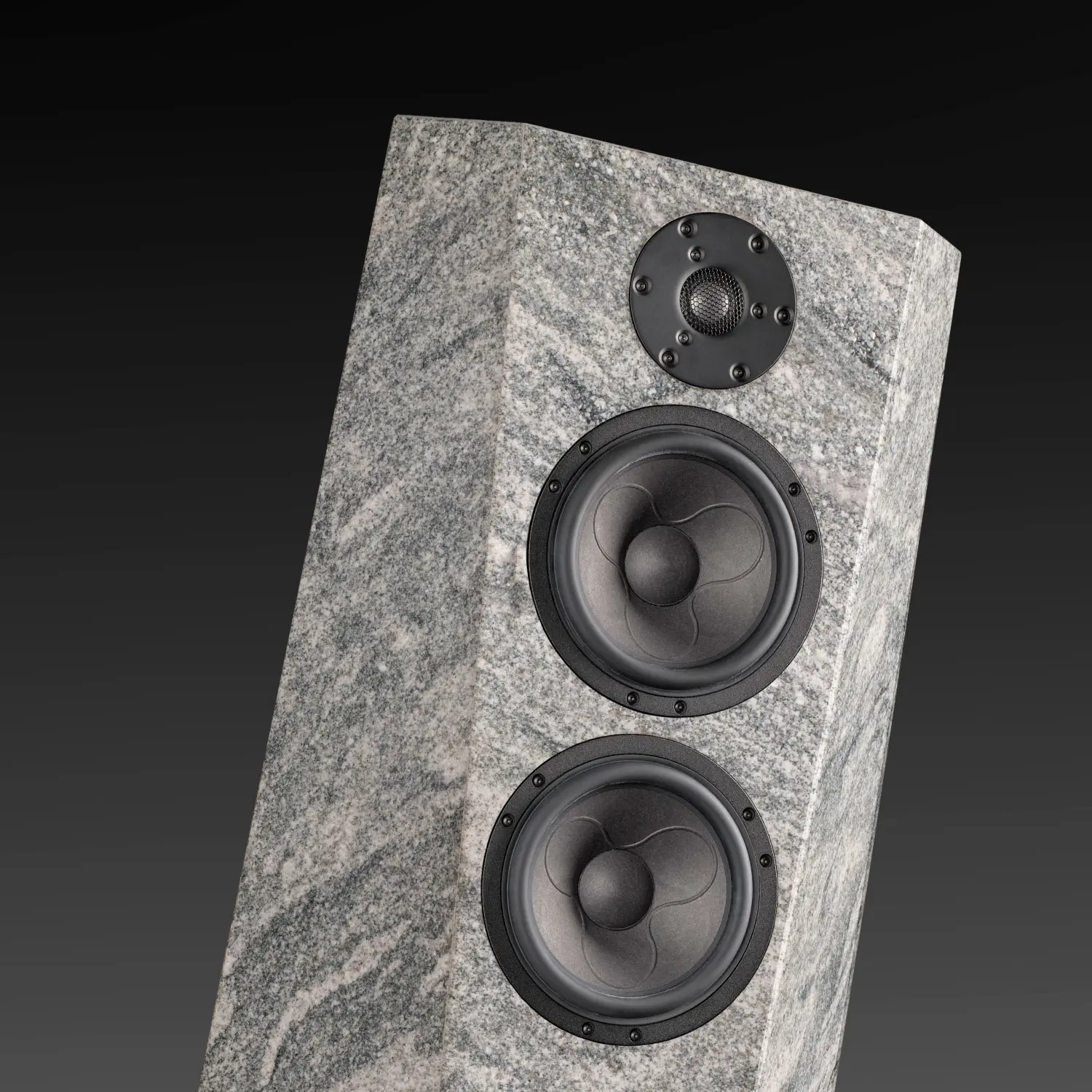 Modern speaker with a textured stone-like finish and three drivers.