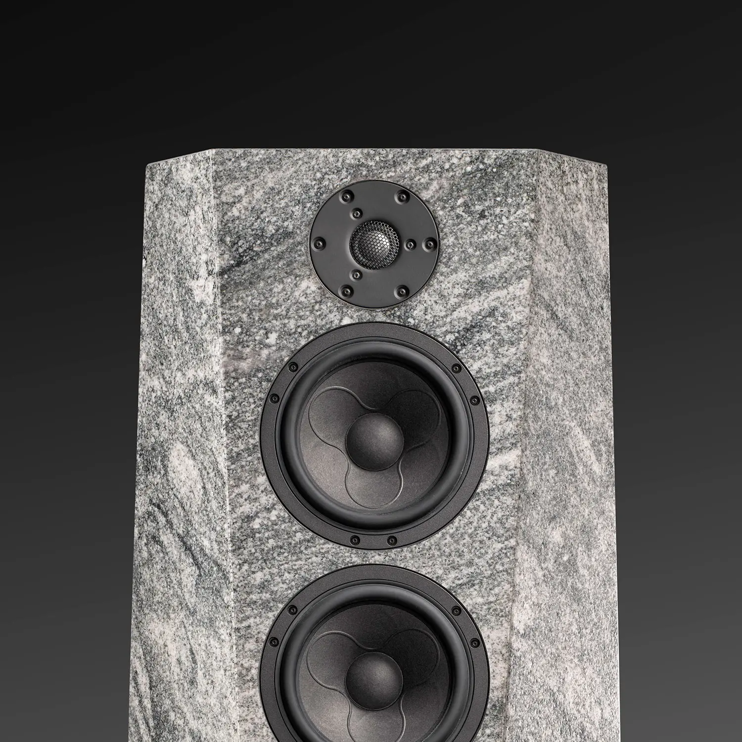 Tall, modern speaker with marble-like finish and three drivers.