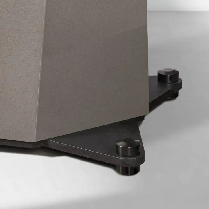 Close-up of a device corner with a stabilizing foot on a gray surface.