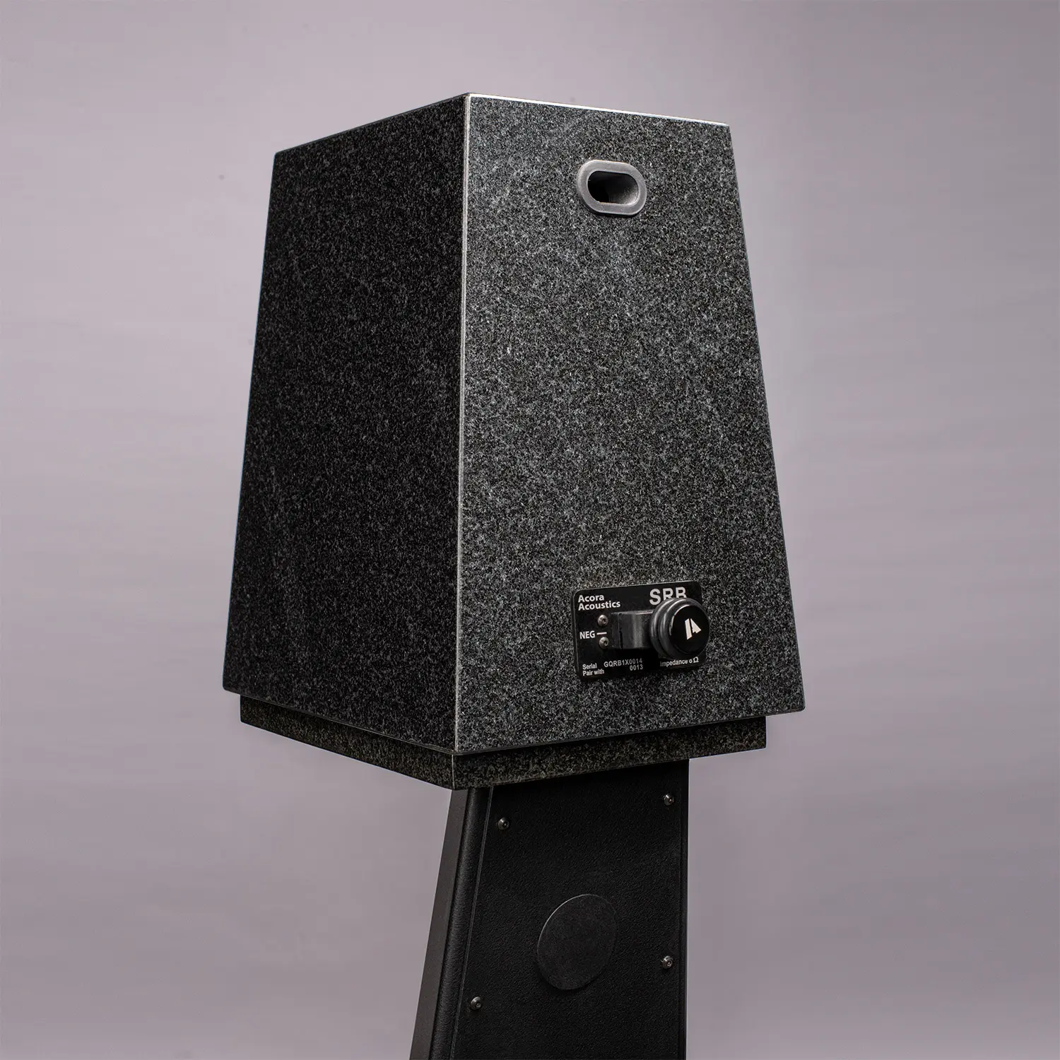 A vintage black speaker with a textured surface and control knobs.