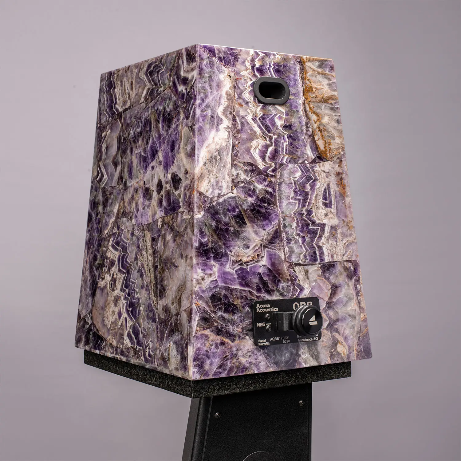 A polished purple and white gemstone sculpture with a unique shape.