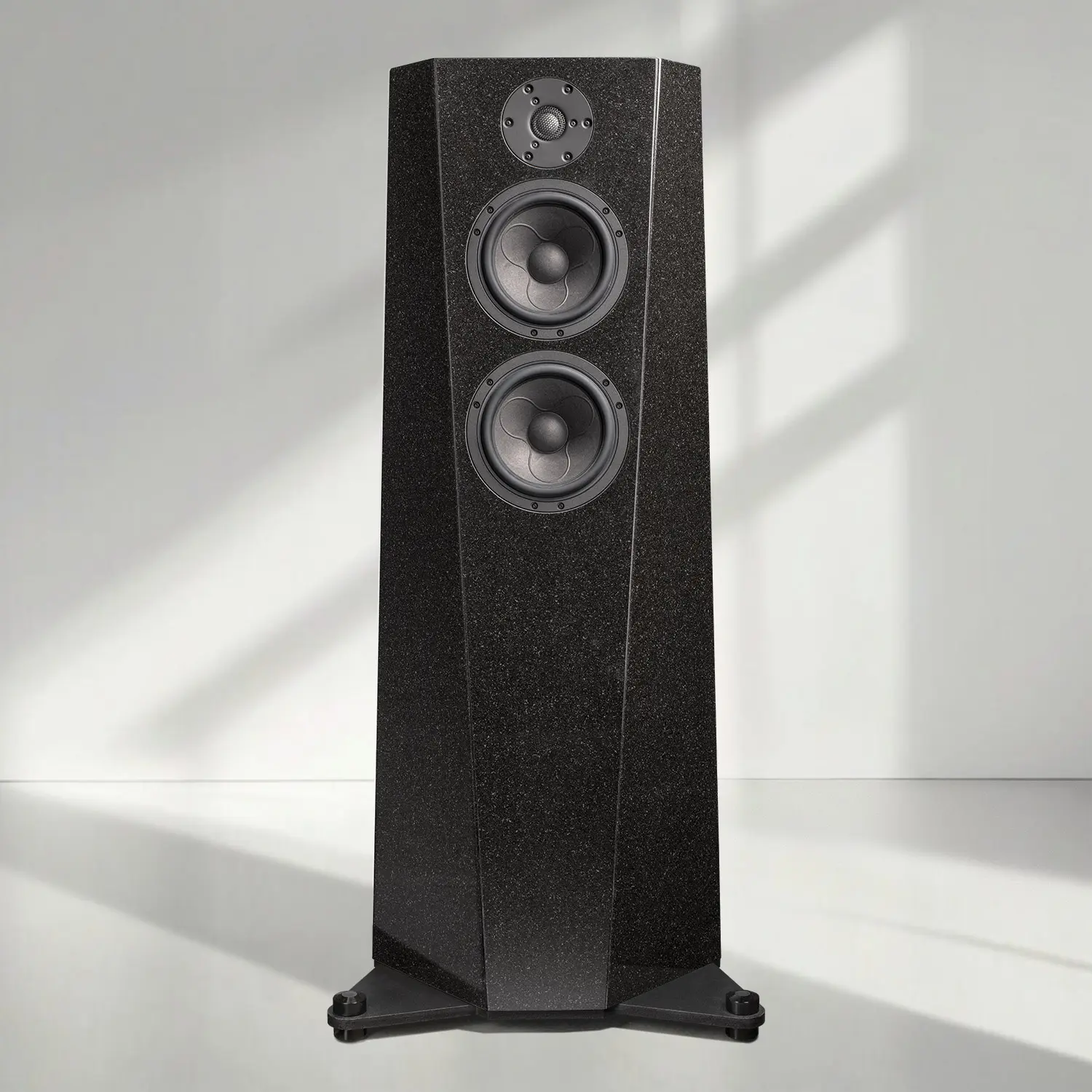 Modern black floor-standing speaker with three drivers.