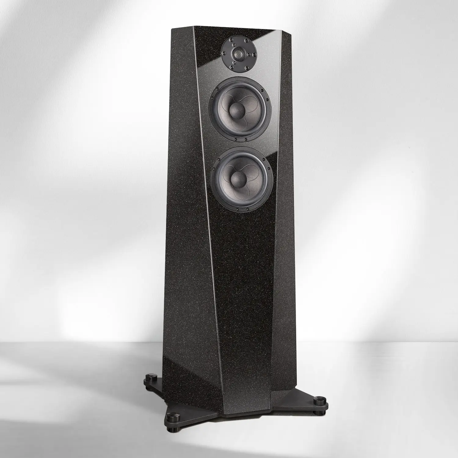 Sleek black floor-standing speaker with three drivers on a stand.