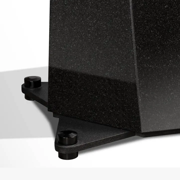 Close-up of a black granite corner base on adjustable feet.