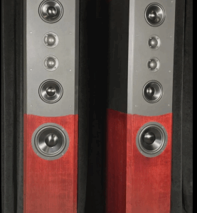 Close-up of tall floor-standing speakers with wood and black finish.