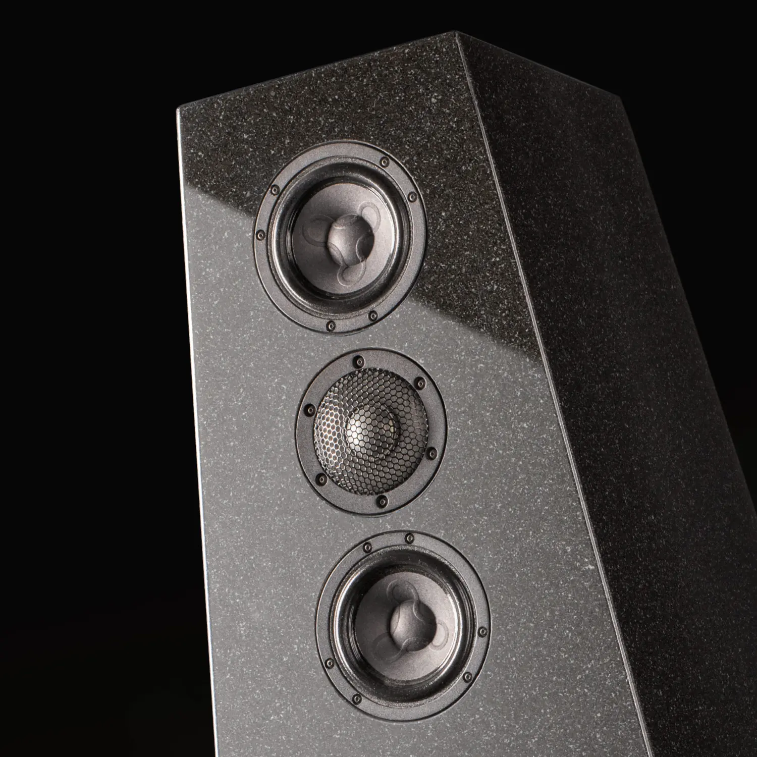 A sleek black speaker with three drivers arranged vertically.