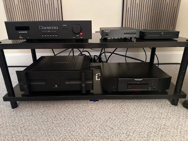 Audio equipment setup with amplifiers and DAC components on a rack.