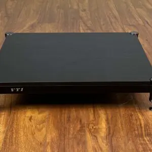 Black electronic device on a wooden floor.