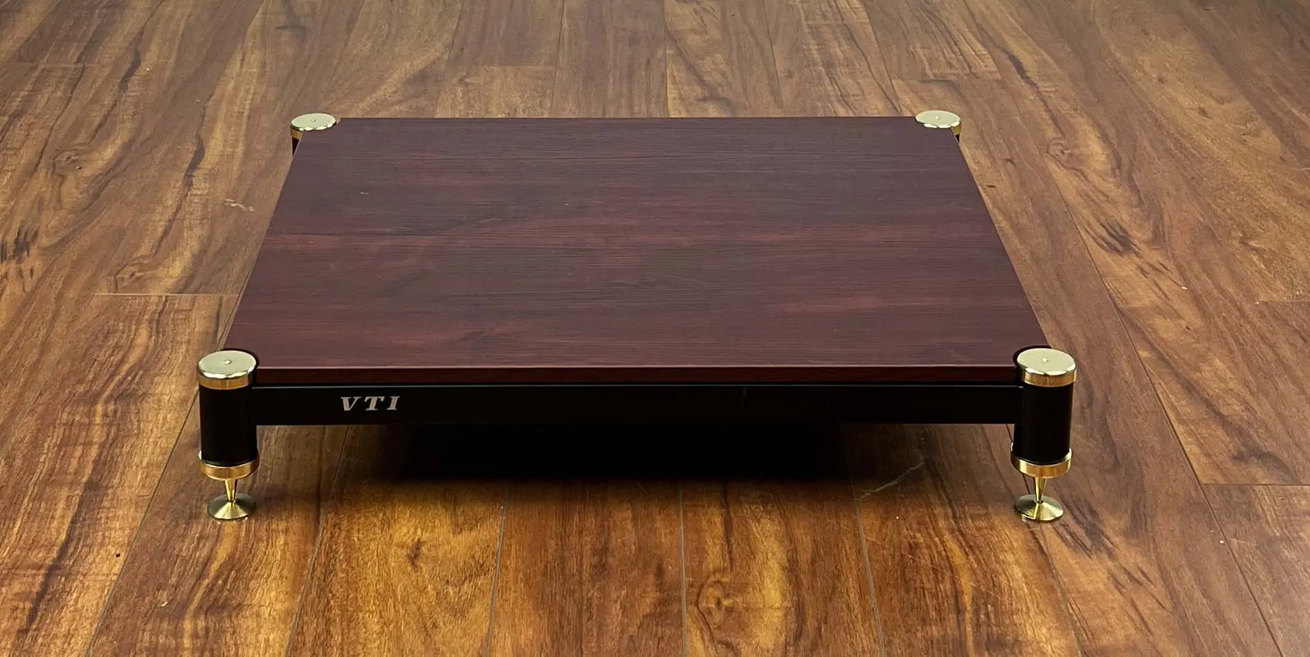 Wooden box with a dark finish on a wooden surface.