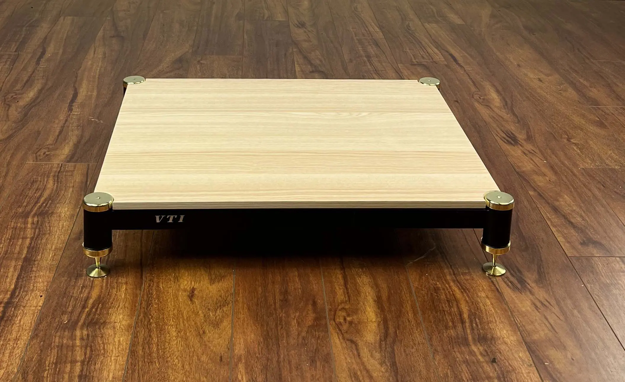 Wooden platform with wheels on a wooden floor.