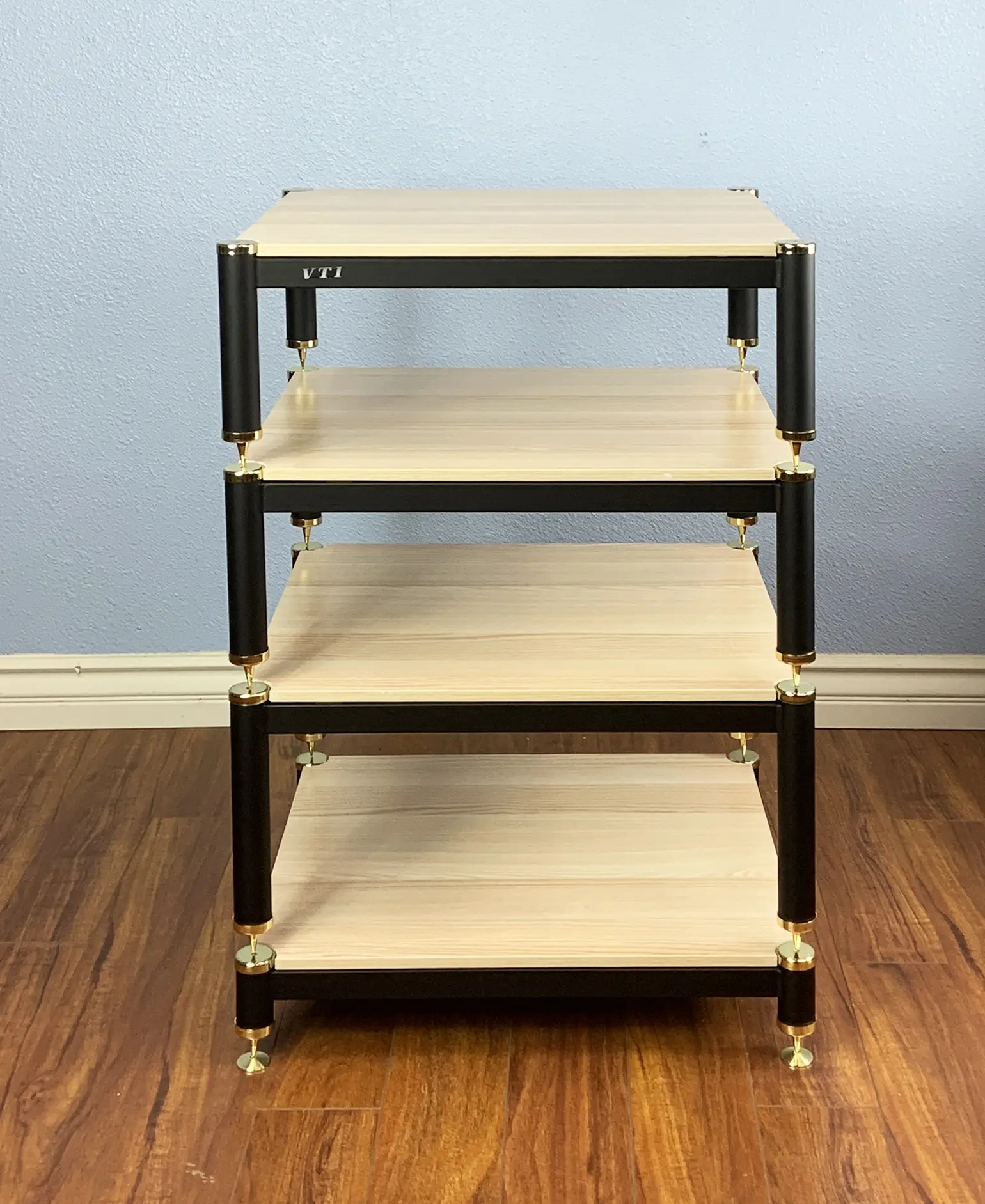 A four-tier wooden shelf with black metal frame and caster wheels.