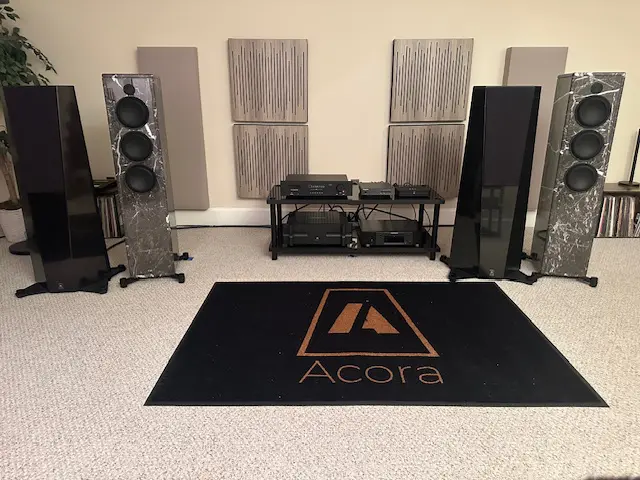 High-end stereo speakers and audio equipment setup in a cozy room.