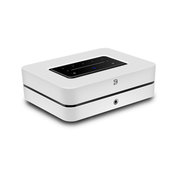 Compact white electronic device with black top panel and ports.