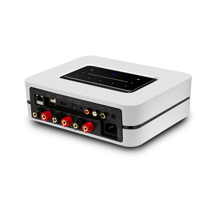 Compact white electronic device with multiple audio connectors and a digital display.